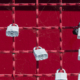 White padlocks on a red fence