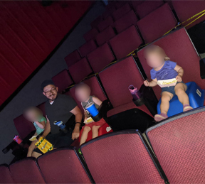 Logan Gruber at the Main Street Theatre in Sauk Centre watching a movie with his three children
